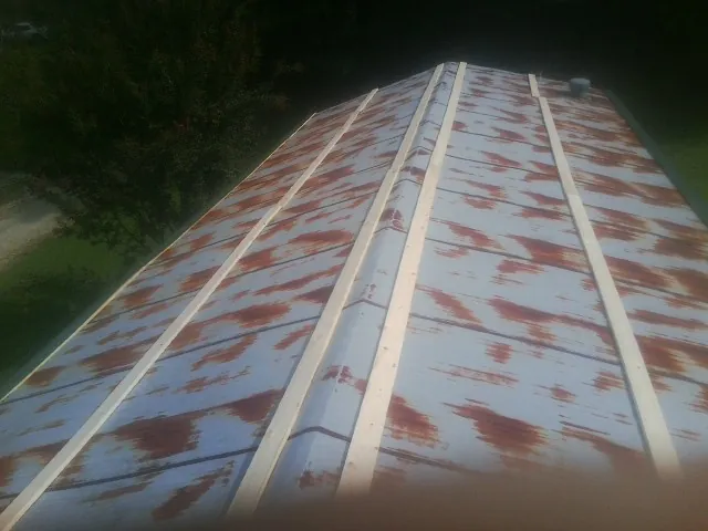 Rusted metal roof panels with new wood purlins before replacement — Storm Damage Roof Repair in Park Ridge by Roofing Brothers