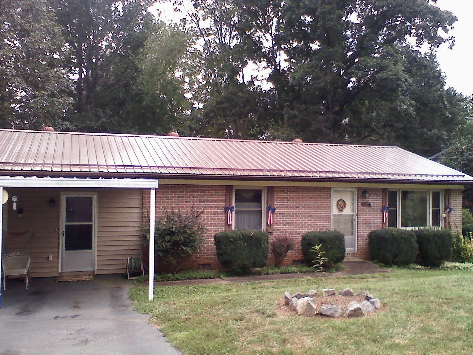 Bronze metal roof and carport on a brick ranch home — Roof Repair work by our crew in Park Ridge